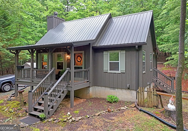 785 Bernhardt Rd, Ellijay, GA 30536 - chalet / cabin with stairway, a porch, a chimney, and metal roof