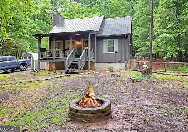785 Bernhardt Rd, Ellijay, GA 30536 - rustic home with a porch, an outdoor fire pit, a chimney, crawl space, and stairway