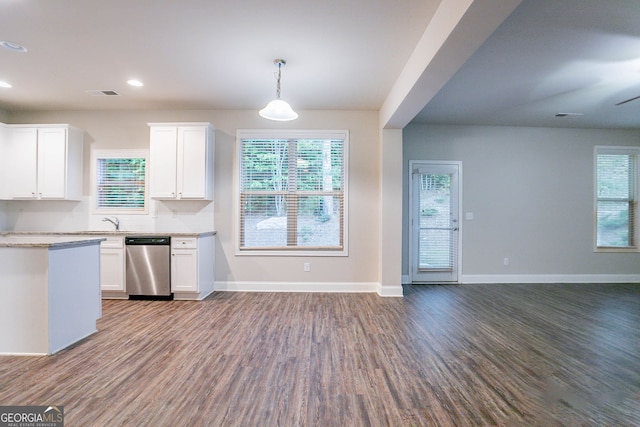 kitchen featuring stainless steel dishwasher, open floor plan, dark wood finished floors, baseboards, and white cabinetry
