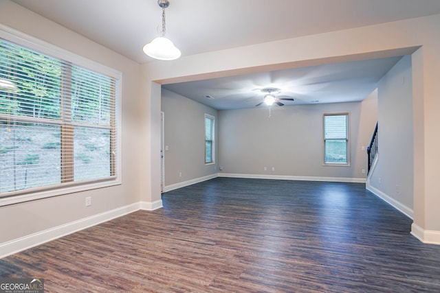 unfurnished room with dark wood-style flooring, baseboards, and ceiling fan