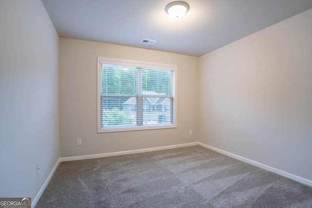 spare room with carpet floors and baseboards