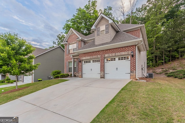 view of front of home featuring roof with shingles, driveway, a front yard, and a garage