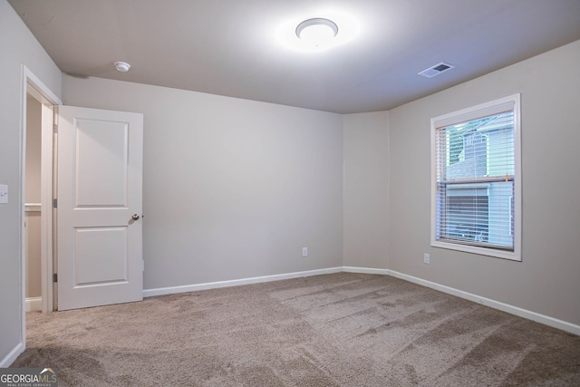 carpeted empty room with baseboards