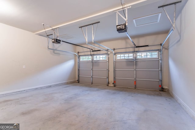 garage featuring a garage door opener and baseboards