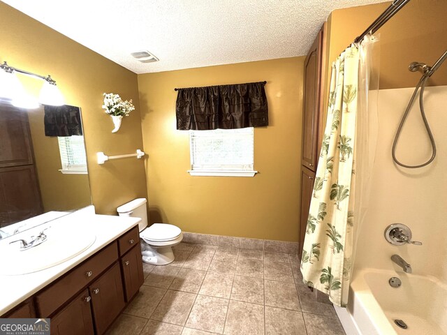 bathroom featuring vanity, tile patterned floors, shower / tub combo, baseboards, and toilet