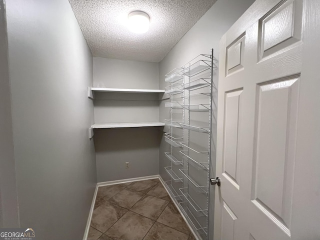 walk in closet featuring tile patterned flooring