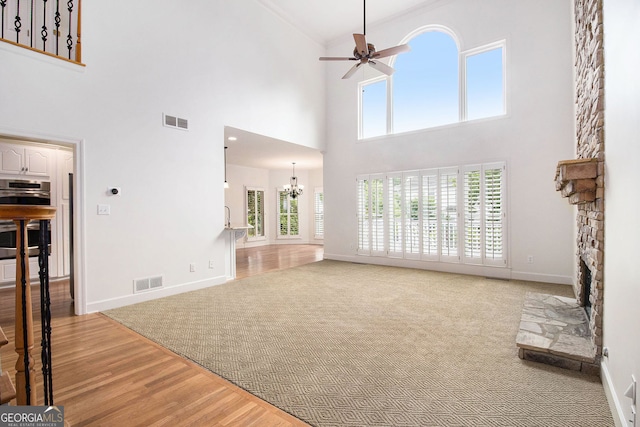 315 Hembree Grove Trce, Roswell, GA 30076 - unfurnished living room featuring a chandelier, a towering ceiling, ceiling fan, baseboards, and wood finished floors
