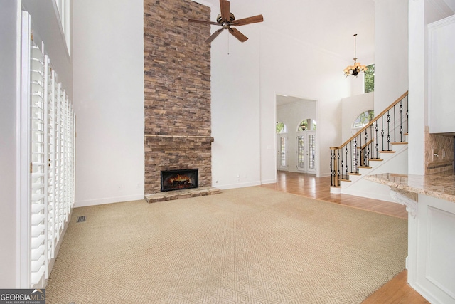 315 Hembree Grove Trce, Roswell, GA 30076 - unfurnished living room with carpet flooring, a high ceiling, a fireplace, ceiling fan, and baseboards