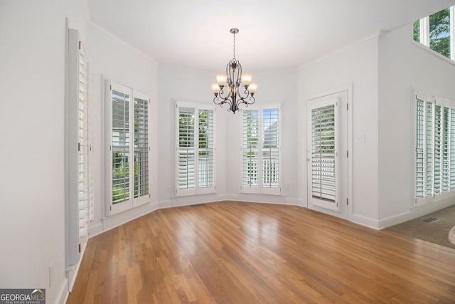 315 Hembree Grove Trce, Roswell, GA 30076 - unfurnished dining area featuring a chandelier, light wood-style floors, ornamental molding, and baseboards