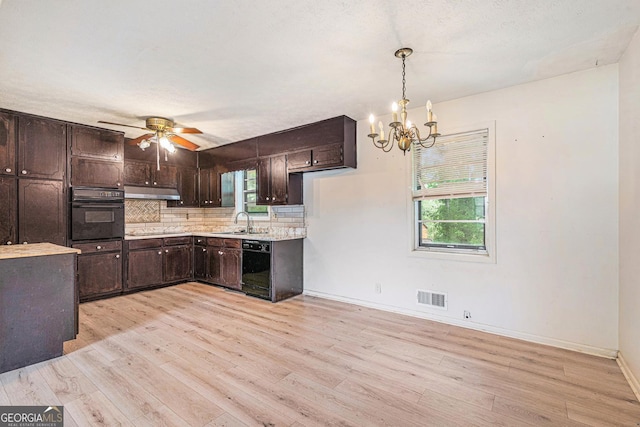 2954 Ann Marie Ln, Rex, GA 30273 - kitchen with black appliances, a chandelier, dark brown cabinets, decorative backsplash, and light wood-style flooring