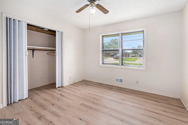 2954 Ann Marie Ln, Rex, GA 30273 - unfurnished bedroom with light wood-style floors, a closet, and ceiling fan