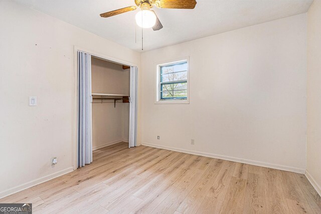 2954 Ann Marie Ln, Rex, GA 30273 - unfurnished bedroom with light wood-style floors, a closet, and a ceiling fan