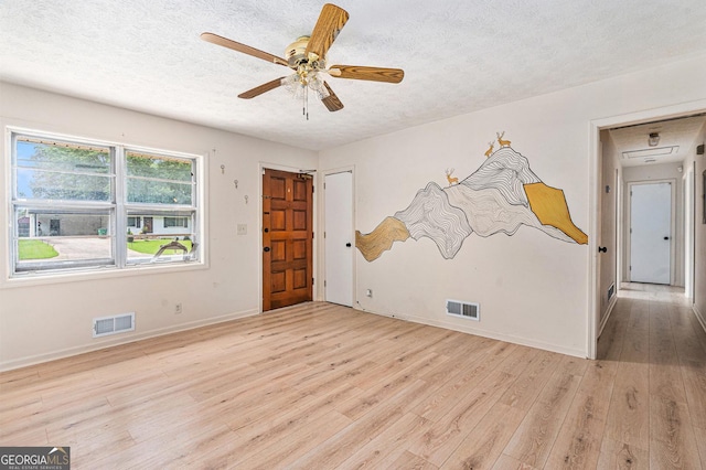 2954 Ann Marie Ln, Rex, GA 30273 - empty room featuring a textured ceiling, light wood-type flooring, and ceiling fan