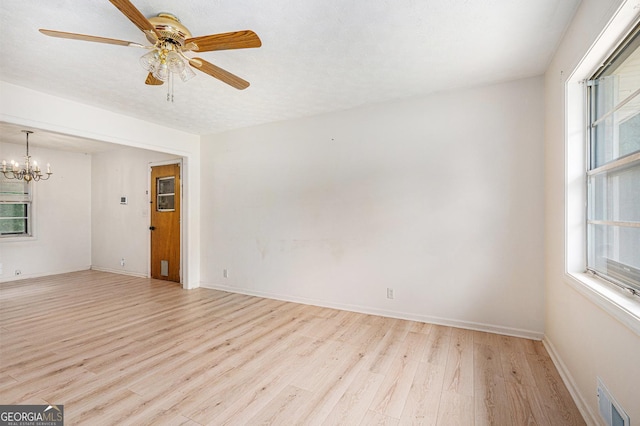 2954 Ann Marie Ln, Rex, GA 30273 - unfurnished room featuring light wood-type flooring, a ceiling fan, and a chandelier