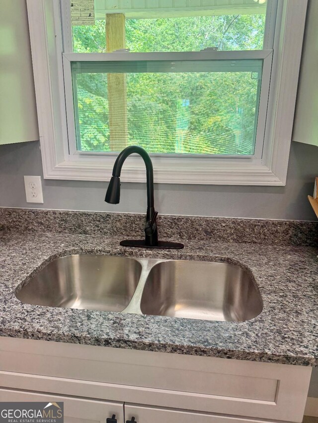 201 Deerfield Ln, Carrollton, GA 30116 - kitchen view of dark stone countertops and white cabinets