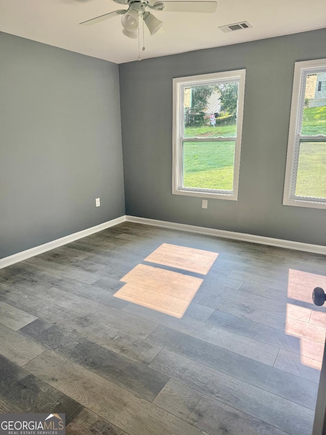 201 Deerfield Ln, Carrollton, GA 30116 - unfurnished room featuring healthy amount of natural light, a ceiling fan, and wood finished floors