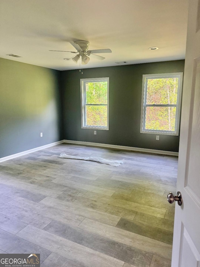 201 Deerfield Ln, Carrollton, GA 30116 - spare room with plenty of natural light, a ceiling fan, baseboards, and wood finished floors
