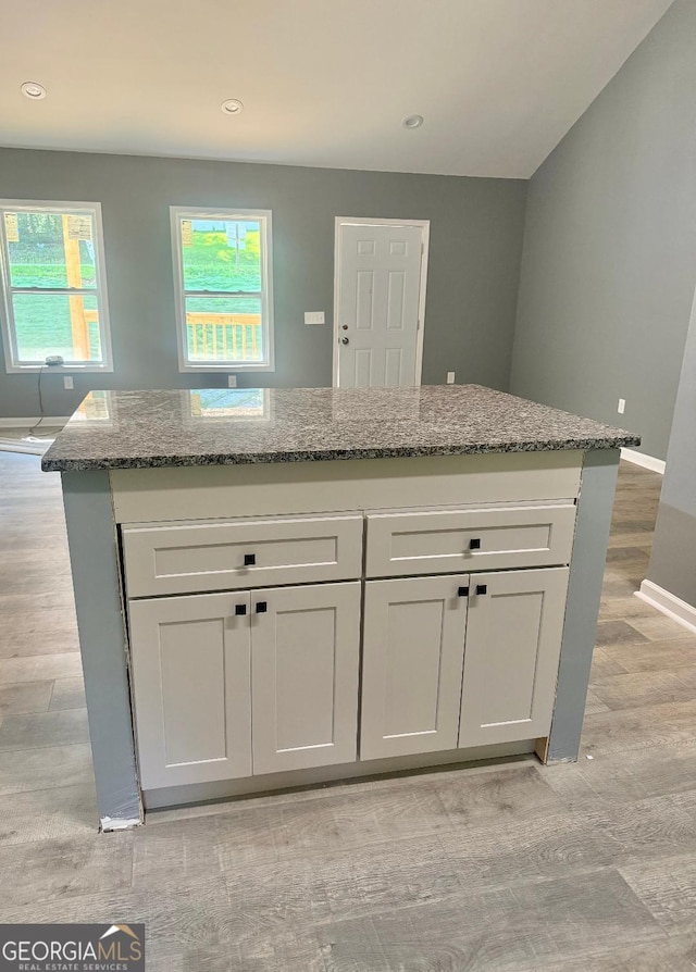 201 Deerfield Ln, Carrollton, GA 30116 - kitchen featuring light wood-type flooring, stone countertops, baseboards, white cabinetry, and recessed lighting