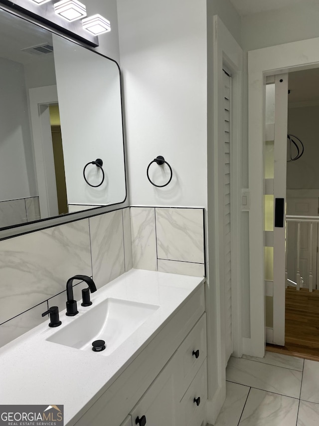 bathroom featuring vanity and marble finish flooring