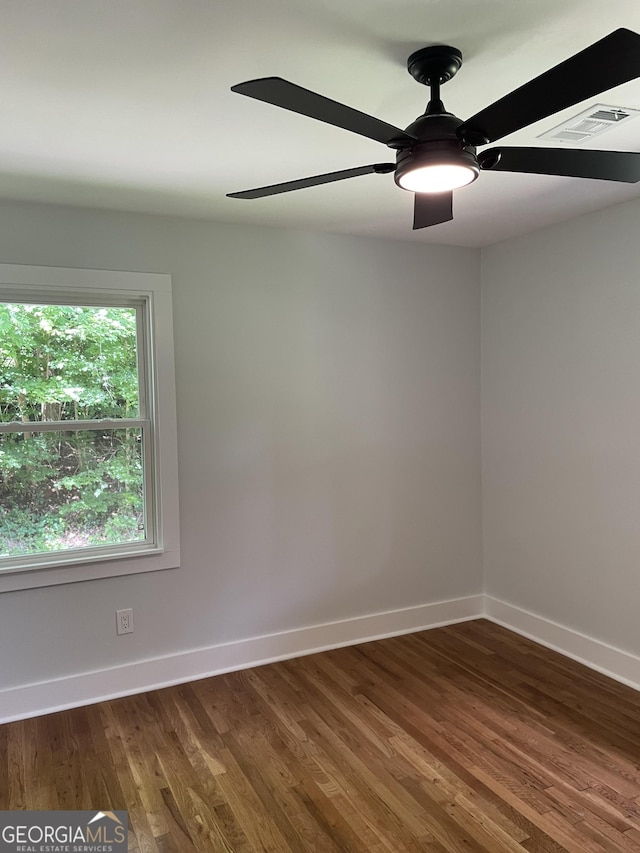 unfurnished room featuring a ceiling fan, baseboards, and wood finished floors