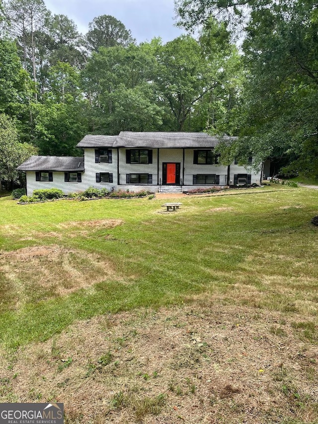 raised ranch featuring a front yard