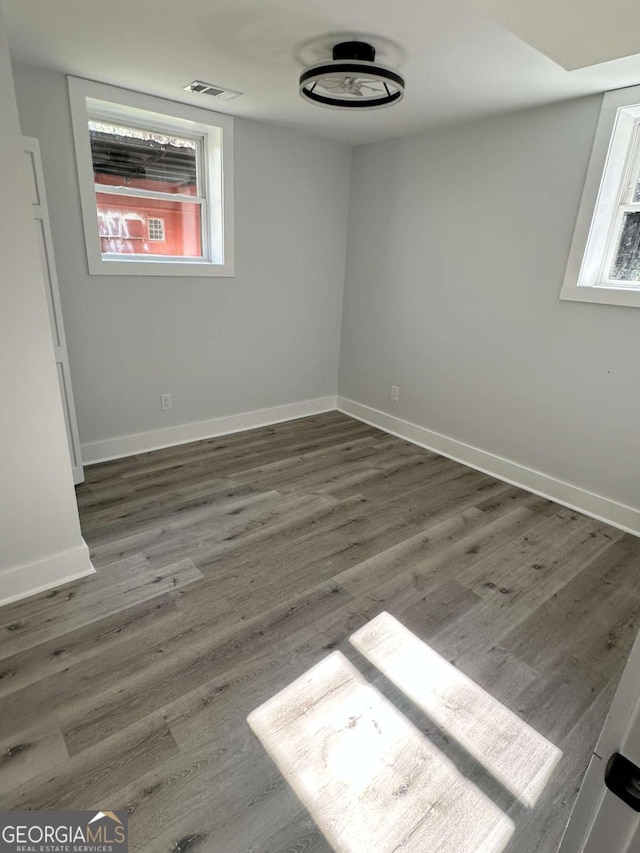 spare room with wood finished floors and baseboards