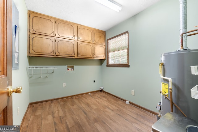 laundry room with cabinet space, hookup for an electric dryer, washer hookup, light wood finished floors, and water heater