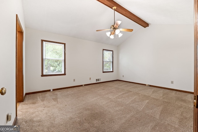 spare room with healthy amount of natural light, light colored carpet, ceiling fan, and baseboards
