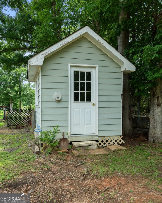 view of shed featuring fence
