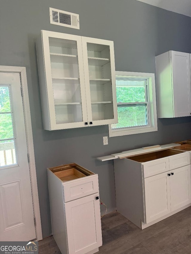 191 Deerfield Ln, Carrollton, GA 30116 - kitchen featuring white cabinetry, dark wood finished floors, and glass insert cabinets