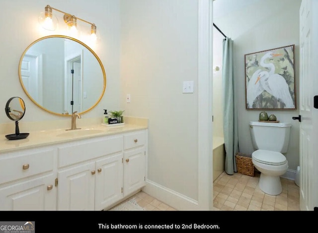 bathroom with tile patterned floors, vanity, toilet, curtained shower, and baseboards