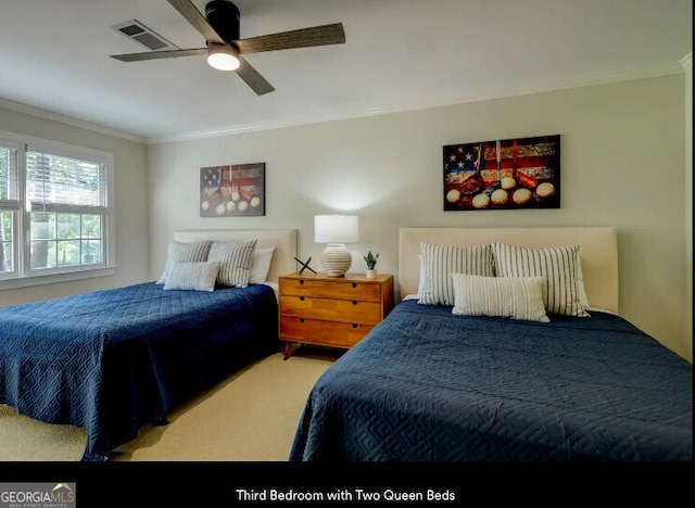 bedroom featuring crown molding, carpet flooring, and a ceiling fan