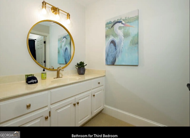 bathroom with vanity and baseboards