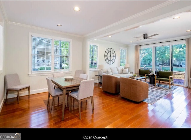 dining room with wood-type flooring, ornamental molding, baseboards, and recessed lighting
