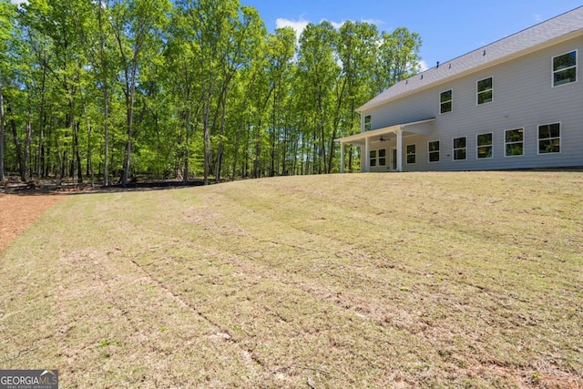 view of green lawn with a ceiling fan