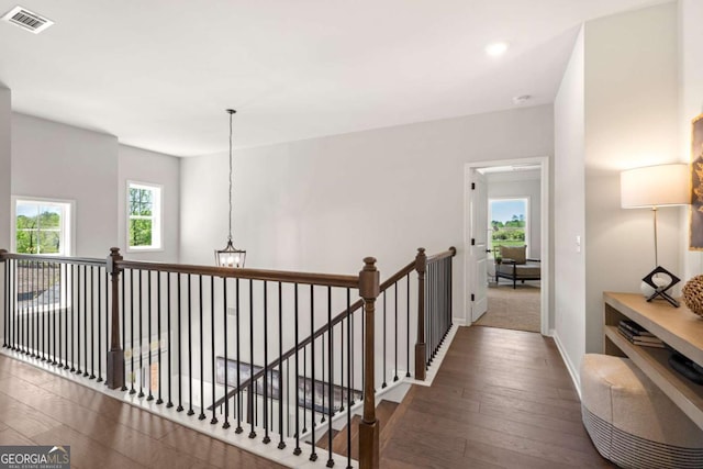 hallway with baseboards, an upstairs landing, wood-type flooring, recessed lighting, and a chandelier