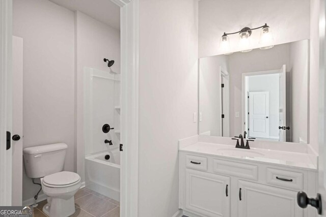 2749 Porches Ln, Dacula, GA 30019 - bathroom featuring tile patterned flooring, toilet, vanity,  shower combination, and baseboards