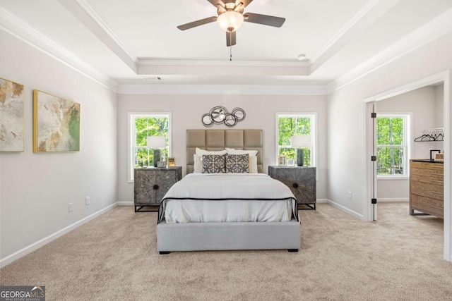 bedroom with multiple windows, a raised ceiling, carpet, and ornamental molding