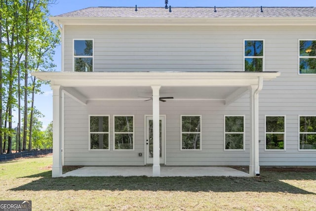 back of property featuring a ceiling fan, a patio area, and a lawn