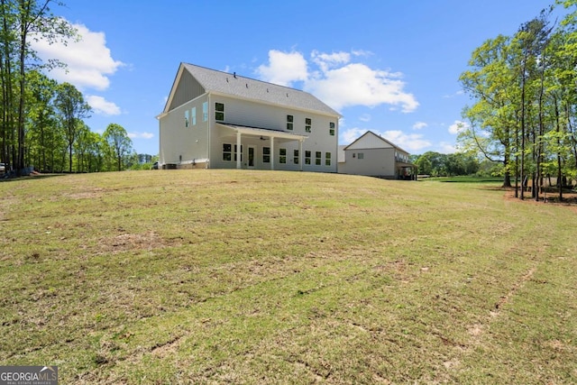 back of property featuring a lawn