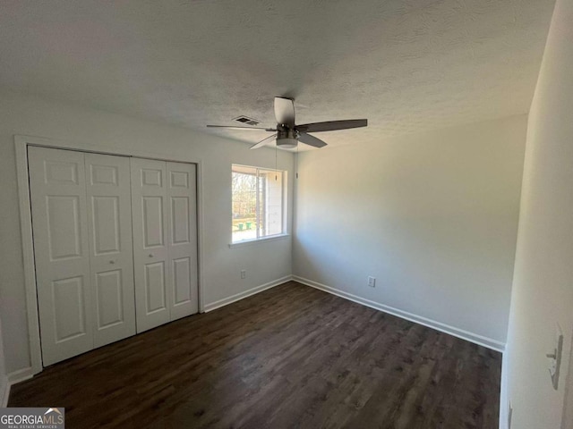 3417 Hollow Tree Dr, Decatur, GA 30034 - unfurnished bedroom with dark wood-style flooring, baseboards, a closet, ceiling fan, and a textured ceiling