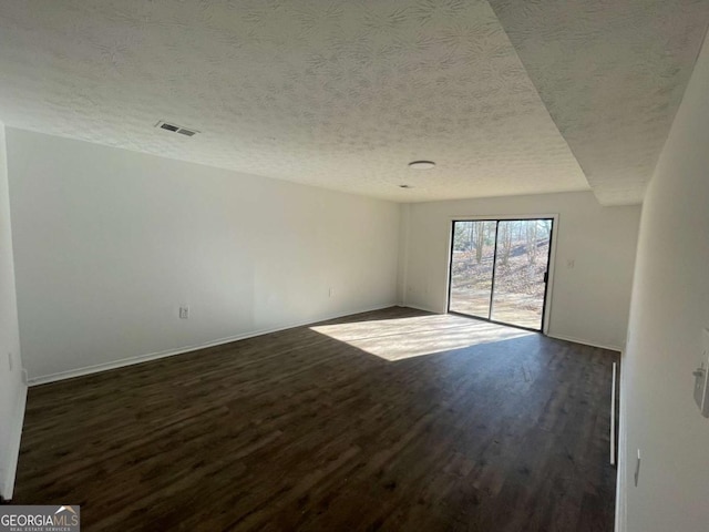 3417 Hollow Tree Dr, Decatur, GA 30034 - unfurnished room featuring dark wood finished floors, a textured ceiling, and baseboards