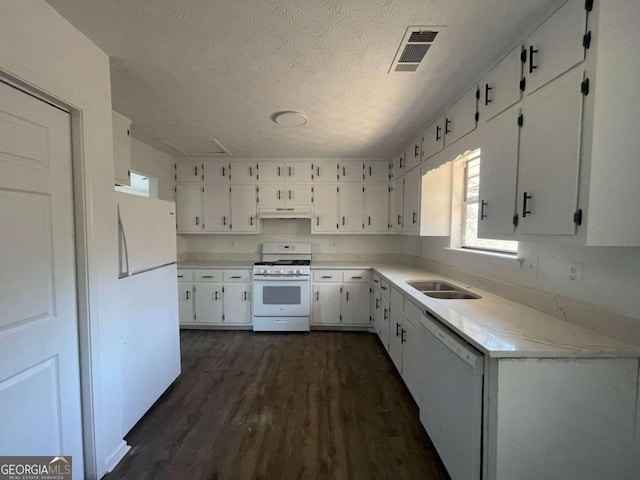 3417 Hollow Tree Dr, Decatur, GA 30034 - kitchen with white appliances, under cabinet range hood, dark wood-type flooring, white cabinets, and light countertops