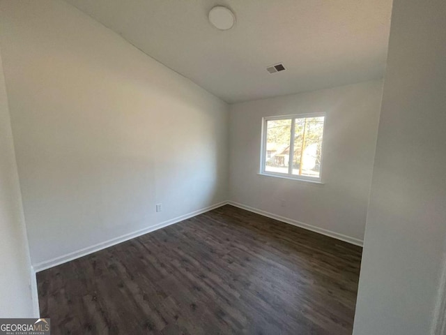 3417 Hollow Tree Dr, Decatur, GA 30034 - empty room with dark wood finished floors, baseboards, and lofted ceiling