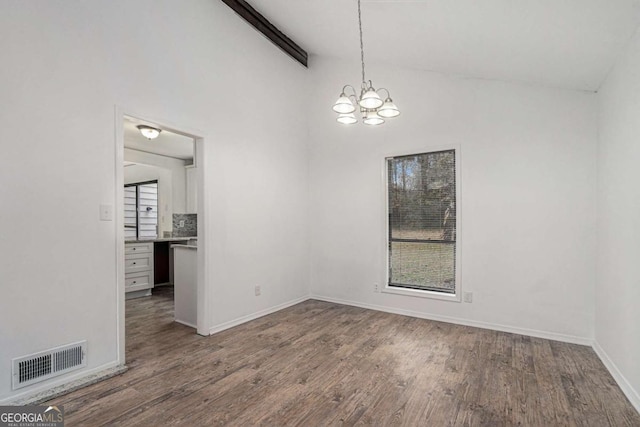 5444 Wylstream, Norcross, GA 30093 - unfurnished dining area featuring a chandelier, wood finished floors, and baseboards