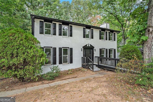 3333 Devaughn Dr NE, Marietta, GA 30066 - colonial-style house featuring a chimney, brick siding, and a wooden deck