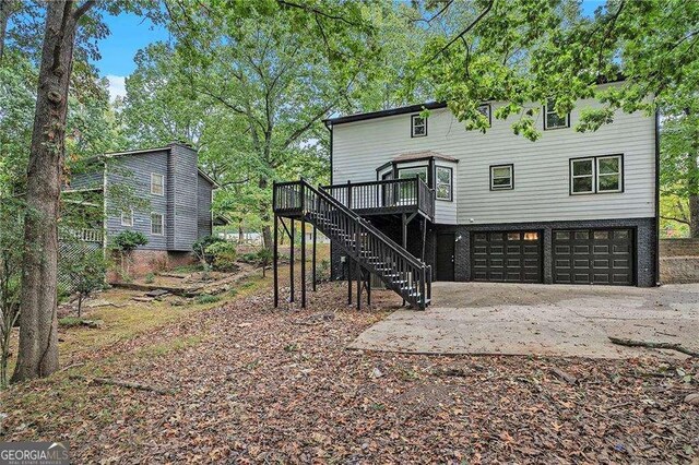 3333 Devaughn Dr NE, Marietta, GA 30066 - back of property featuring stairs, a garage, a deck, and driveway