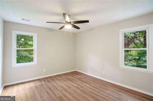 3333 Devaughn Dr NE, Marietta, GA 30066 - unfurnished room featuring wood finished floors, baseboards, ceiling fan, and a textured ceiling
