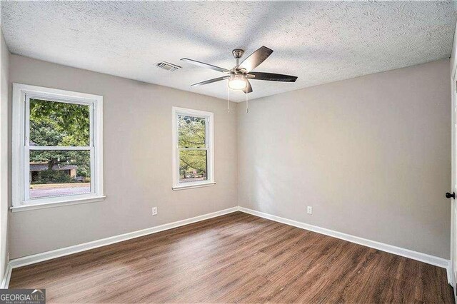 3333 Devaughn Dr NE, Marietta, GA 30066 - empty room with wood finished floors, a ceiling fan, baseboards, and a textured ceiling