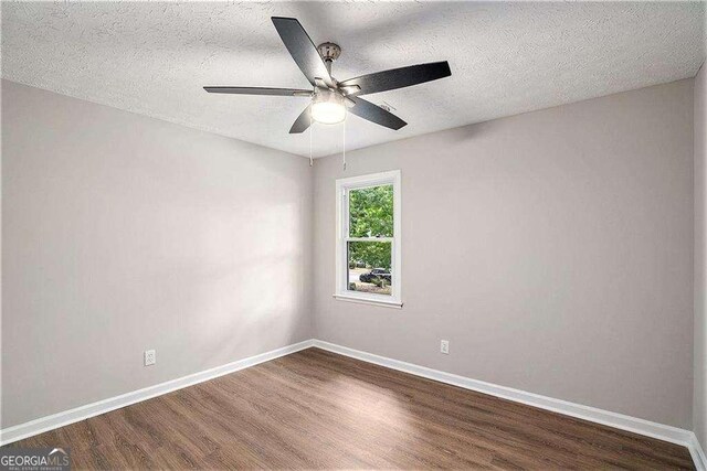 3333 Devaughn Dr NE, Marietta, GA 30066 - empty room featuring dark wood-style floors, baseboards, ceiling fan, and a textured ceiling